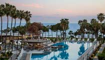 One of the main outdoor swimming pools with its Pool Bar and the sea in the background