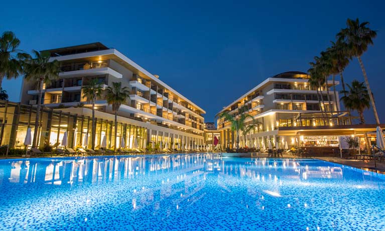 The hotel at night with the swimming pool illuminated