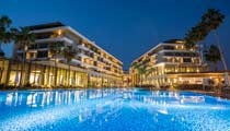 The hotel at night with the swimming pool illuminated