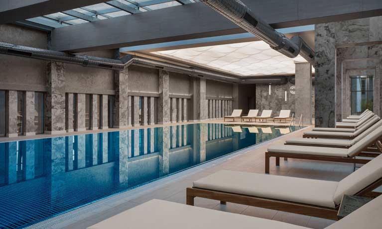 The indoor swimming pool, a calm relaxing space with loungers for guest to relax between swims