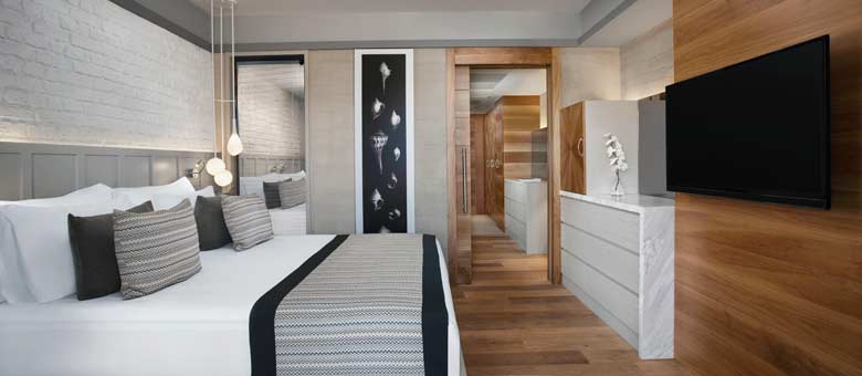 Photo shows a well appointed hotel suite featuring modern decor and five star facilities, the room is welcoming and bright with plenty of space.