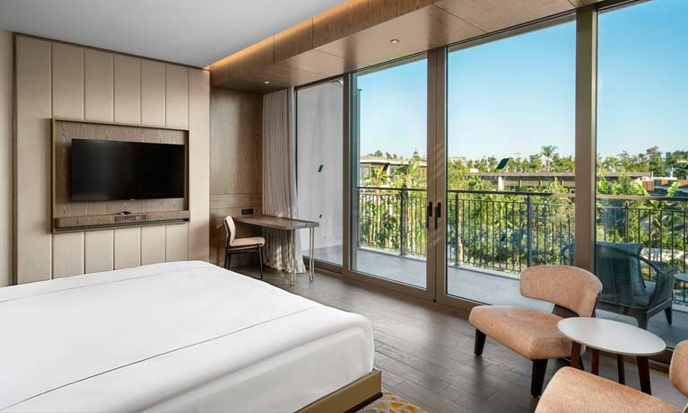Photo shows one of the 5 star hotel rooms at a Barut Collection resort with scenic vies across the landscaped gardens and a high standard of accommodation