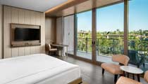 Photo shows one of the 5 star hotel rooms at a Barut Collection resort with scenic vies across the landscaped gardens and a high standard of accommodation