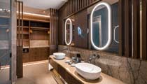 A well equipped and luxurious bathroom at one of the villas with a walk in wardrobe behind