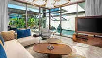 A bright and homely living area in one of the villas with a private swimming pool outside of the large windows