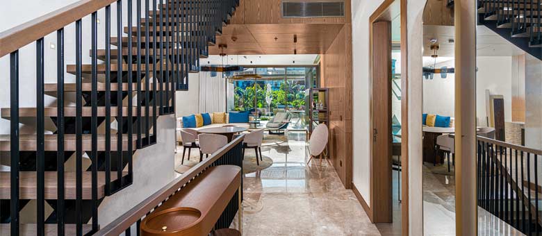 Set on multiple levels the Two Bedroom Villa ground floor can be seen with the dining area and ample garden in the background