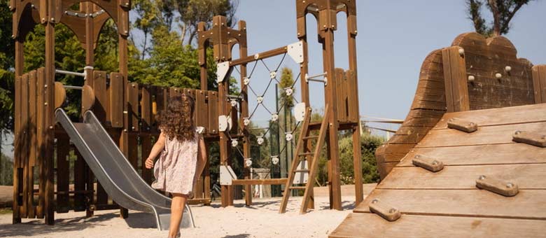 A young hotel guest enjoys the children's playground at Ikos Andalusia