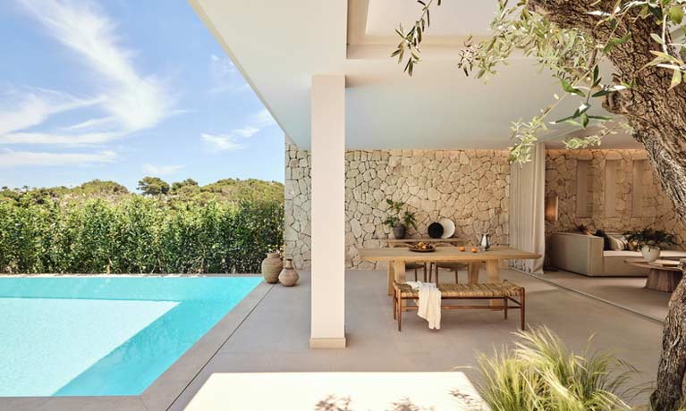Around the pool of a Deluxe Collection suite with outdoor furniture provided for guests comfort.