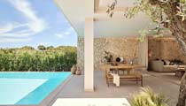 Around the pool of a Deluxe Collection suite with outdoor furniture provided for guests comfort.