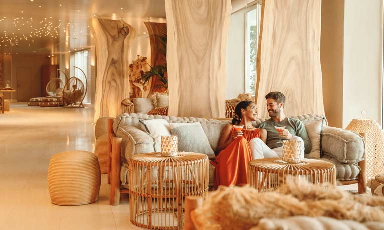 A couple enjoy an evening drink in a bar exclusively reserved for Deluxe Collection guests.