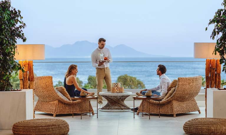 A couple are waited on by attentive staff as they enjoy a relaxing drink at the Lobby Bar.