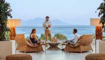 A couple are waited on by attentive staff as they enjoy a relaxing drink at the Lobby Bar.