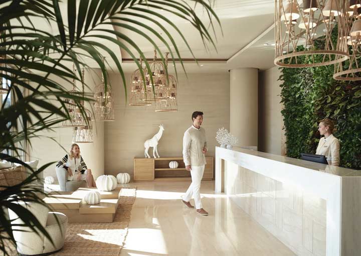 A guest chats to the hotel concierge at the reception of the Ikos Resort