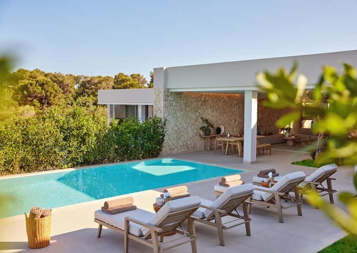 The garden area of a Deluxe Collection suite with sun loungers positioned around the private swimming pool.