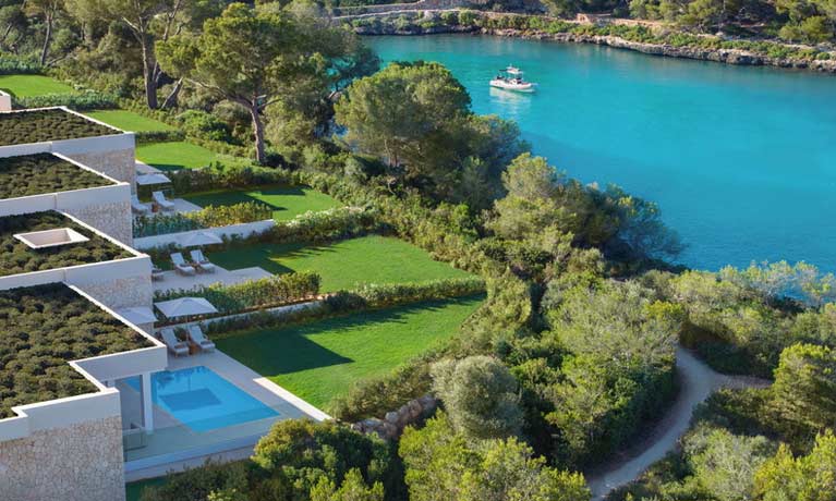 Aerial view of bungalow suites with private pools and large gardens.