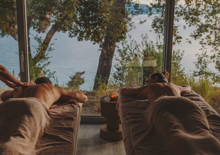 Each of the Ikos Hotel's has it's own Spa. A couple enjoy a massage session together from qualified staff in the tranquil hotel spa.