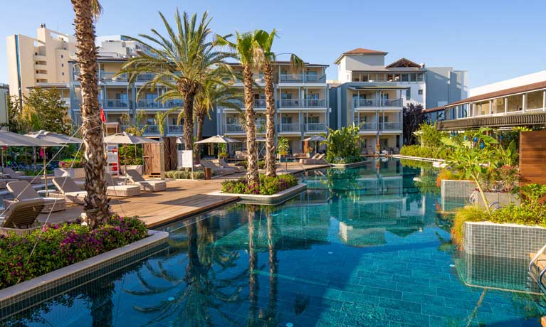 One of the hotel's main outdoor swimming pools, with crystal clear inviting water and surrounded by palm trees it is a calm relaxed environment