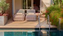 A swim-up room, with its outside terrace featuring a pair of sun loungers and direxct access to the adjacent swimming pool