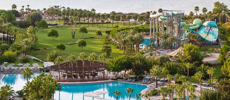 The landscaped gardens and outdoor swimming pools at Lara Barut Collection with the children's water park and beach beyond.