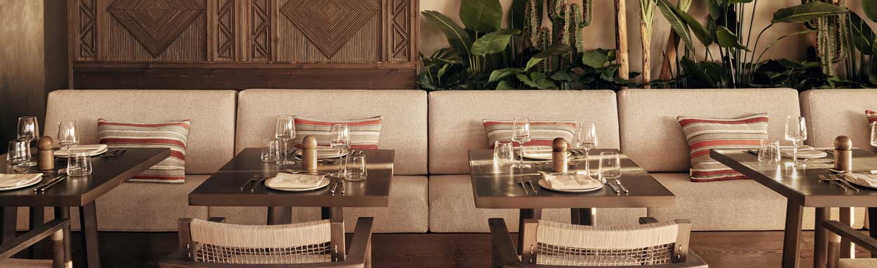Indoor seating with tables set, ready for guests to arrive for evening dinner